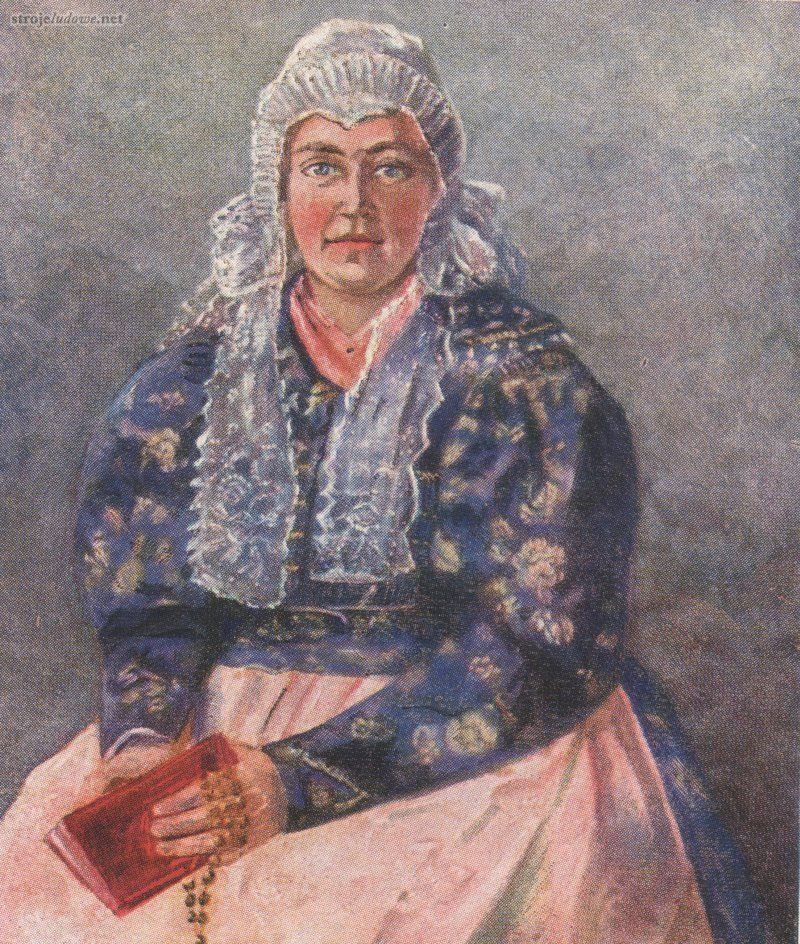 Kobieta w kaftanie i kolorowej chustce na szyi, Grabowski E., <em>Die Volkstrachten in Oberschlesien</em>, Breslau, 1935 r., własność prywatna

Przy szyi kaftan posiadał zwykle duży, owalny podkrój, w którym widoczna była zawiązana na szyi niewielka czerwona lub różowa chusteczka. Do brzegów dekoltu doszywano półkolisty opadający aż na plecy kołnierz, a dolna krawędź kaftana wykończona była węższą lub szerszą, prostą albo ułożoną w zakładki baskinką.